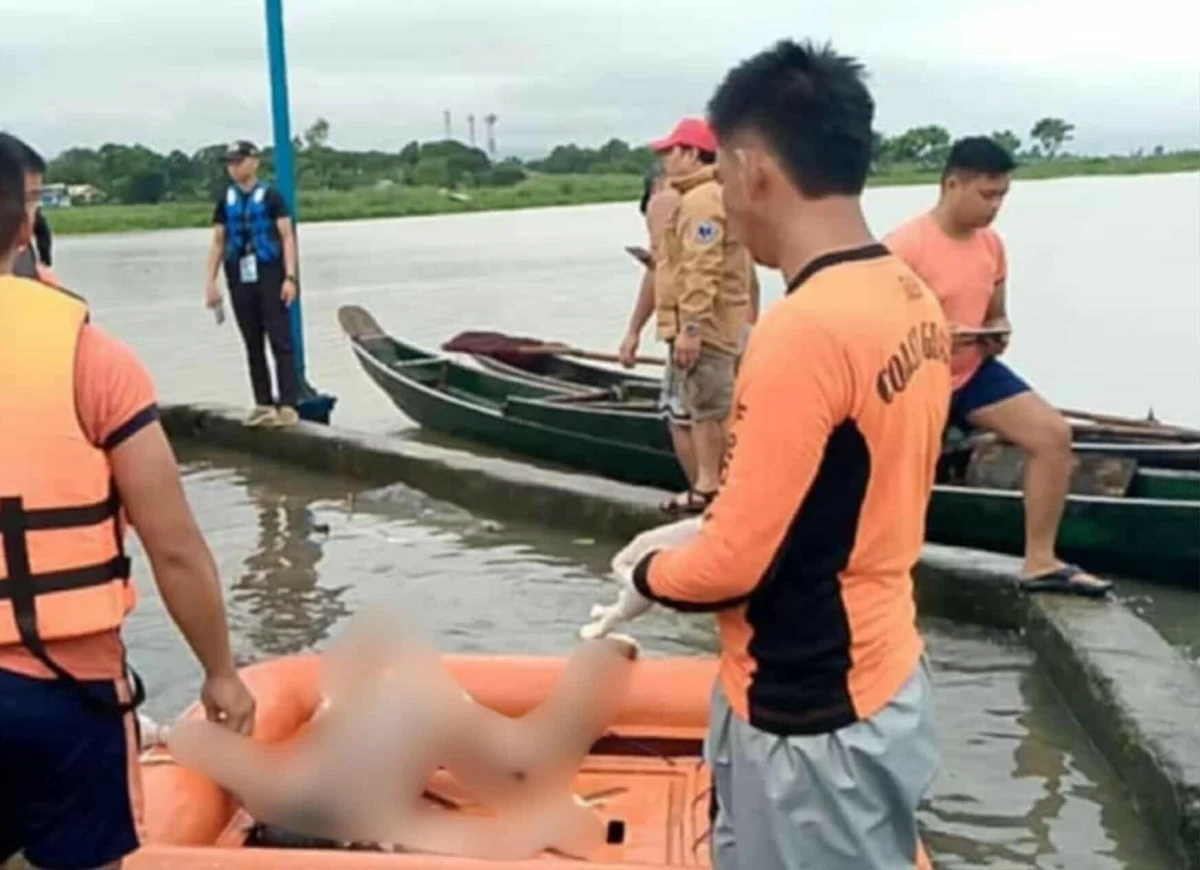 Rescuers recover the bodies of two boys swept away by strong river currents in Morong, Rizal. (Photos from Barangay San Isidro)