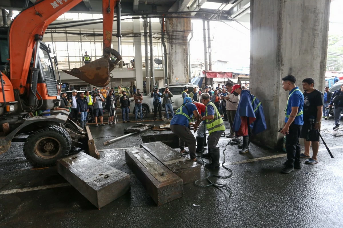 The collection of debris in a drainage system below Batasan Station of the MRT-7 in Quezon City on Wednesday, July 23, 2025. (Santi San Juan)