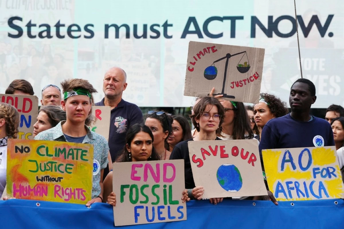 Activists demonstrate outside the International Court of Justice ahead of an advisory opinion on what legal obligations nations have to address climate change and what consequences they may face if they don't, Wednesday, July 23, 2025, in The Hague, Netherlands. (AP Photo/Peter Dejong)