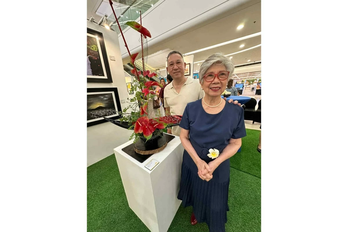 Neny Regino and her son Miguel, by her Ikebana work