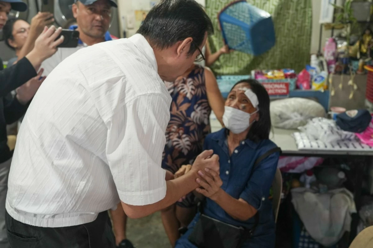 Mayor Isko checks the condition of a senior citizen who was victimized by the uneven asphalt overlay along F. Manalo St. in Punta, Sta. Ana.