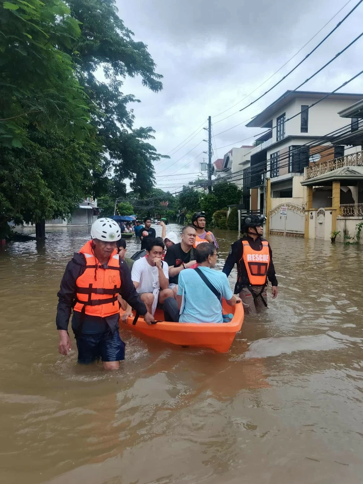Rescuers use lifeboats to transport citizens through flooded areas in Antipolo City.