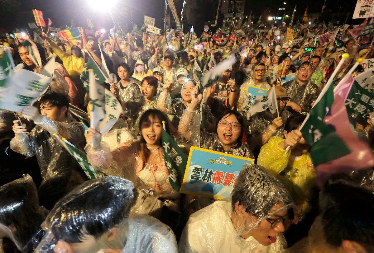 People shoot slogans during a campaign rally to promote recall vote targeting 24 Nationalist Party (KMT) lawmakers in Taipei, Taiwan, Thursday, July 24, 2025. (AP Photo/Chiang Ying-ying)