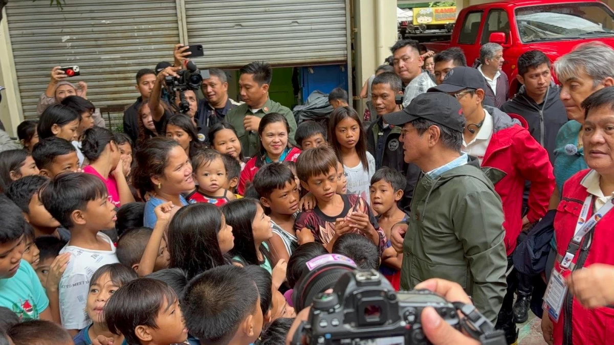 President Ferdinand 'Bongbong' Marcos Jr. checks on the families who evacuated to the Tanza National High School due to the rising floods caused by the recent weather systems in Navotas City. Around 162 families were seeking shelter at the school as of July 26, 2025. (MPC Pool)