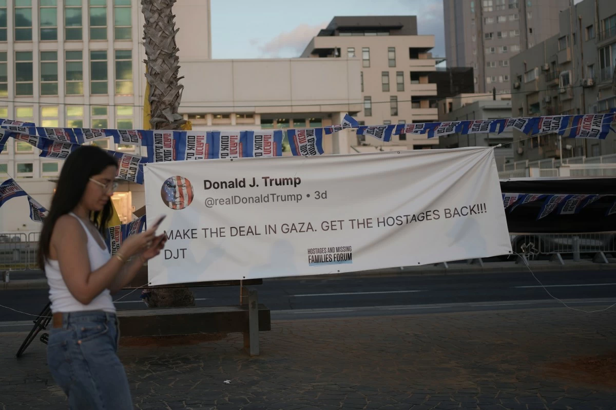 A PERSON walks past a sign during a protest outside US Embassy Branch demanding the end of the war and immediate release of hostages held by Hamas in the Gaza Strip, and against Prime Minister Benjamin Netanyahu's government in Tel Aviv, Israel, Saturday, July 19, 2025. (AP)