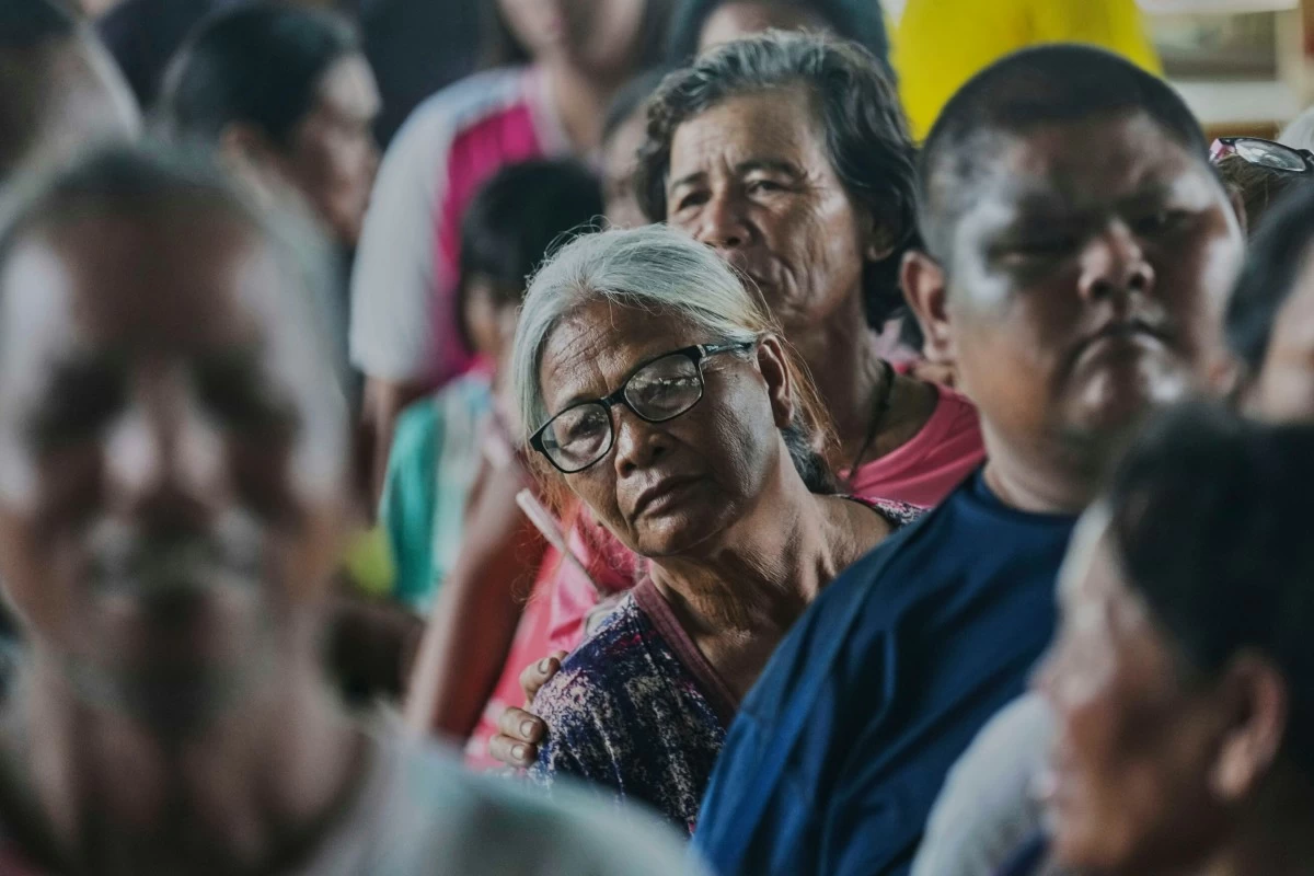 Thai residents who fled homes following clashes between Thai and Cambodian soldiers line up to receive toiletry distributed by a group of elderly in Surin who learn ballroom dance together, at an evacuation center in Surin province, Thailand, Saturday, July 26, 2025. (AP Photo/Sakchai Lalit)