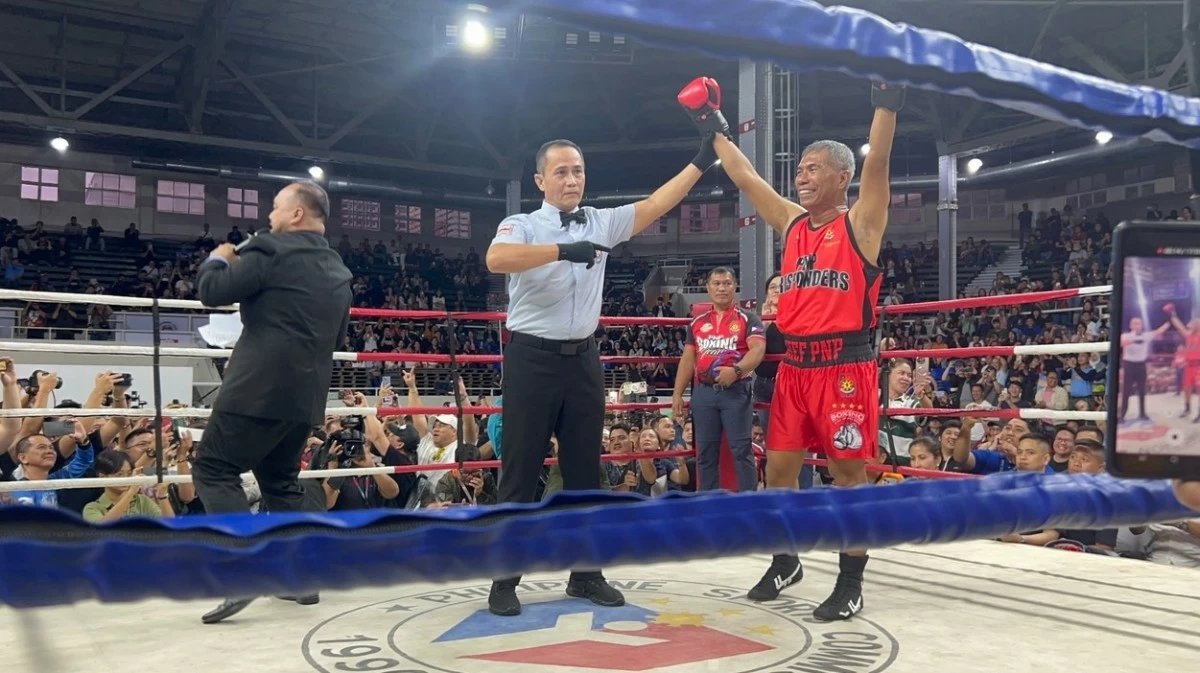 PNP chief Gen. Nicolas Torre III raises his hands after the ring announcer declared him as a the winner after acting Davao City Mayor Sebastian "Baste" Duterte snubbed the charity boxing event at the Rizal Memorial Coliseum in Manila on Sunday, July 27, 2025. (photo: Aaron Recuenco)