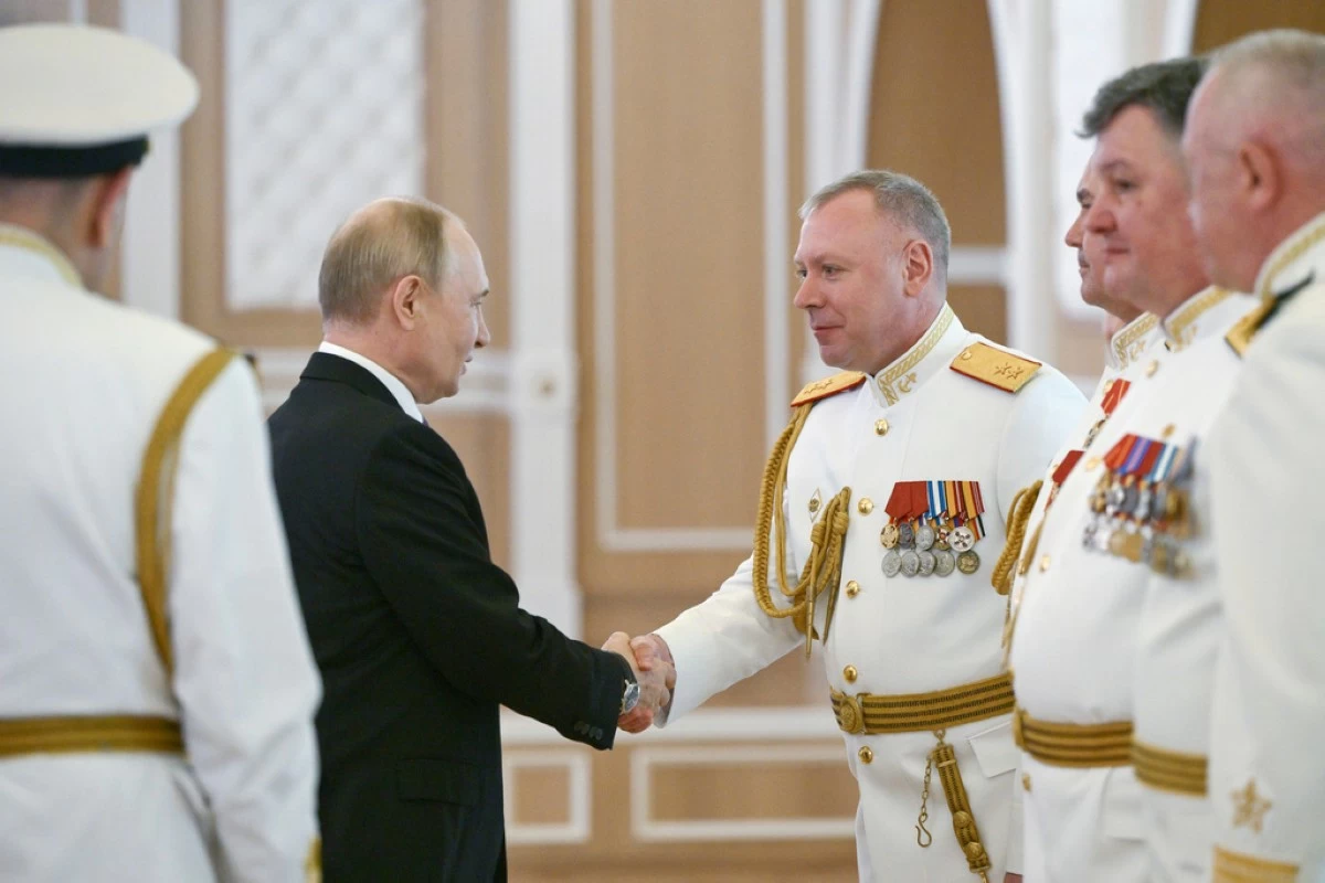 Russian President Vladimir Putin, left, shakes hands with Russian Navy officers during his visit to St. Petersburg on Navy Day, Russia, on Sunday, July 27, 2025. (Alexei Danichev, Sputnik, Kremlin Pool Photo via AP)