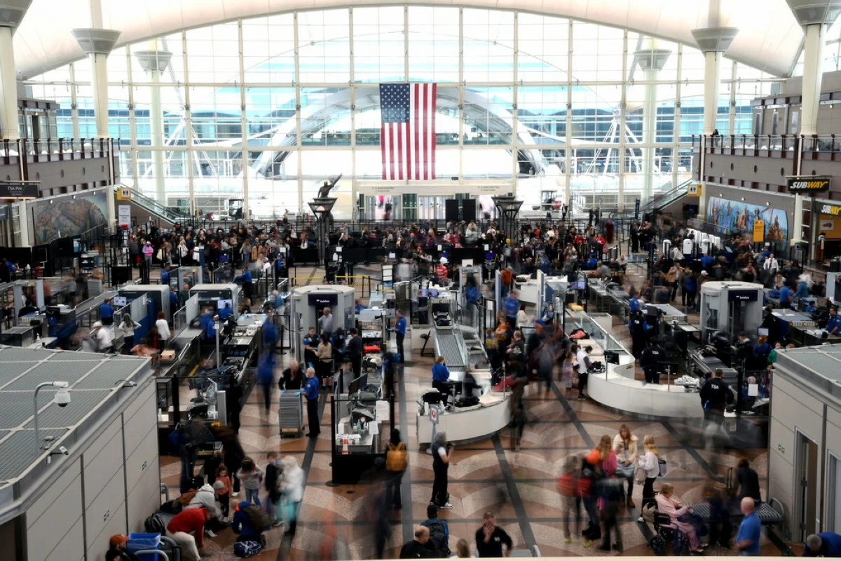 FILE - Passengers wait in a security line at Denver International Airport on Feb. 22, 2023. (AP Photo/Thomas Peipert, File)