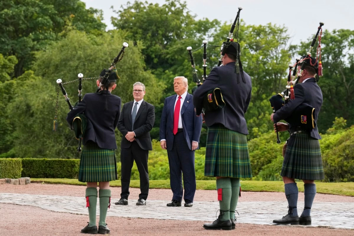 President Donald Trump, third right, and Britain's Prime Minister Keir Starmer, fourth right, are welcomed at Trump International Golf Links, near Aberdeen, Scotland, Monday, July 28, 2025. (AP Photo/Jacquelyn Martin)