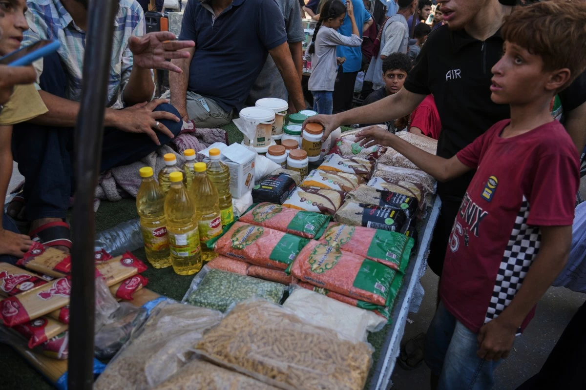 Palestinian vendors display goods for sale at a street market in Gaza City, Wednesday, July 23, 2025. (AP Photo/Jehad Alshrafi)