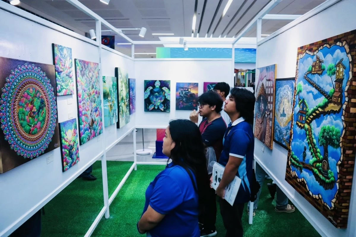 Guests take a closer look at the artworks displayed in the gallery