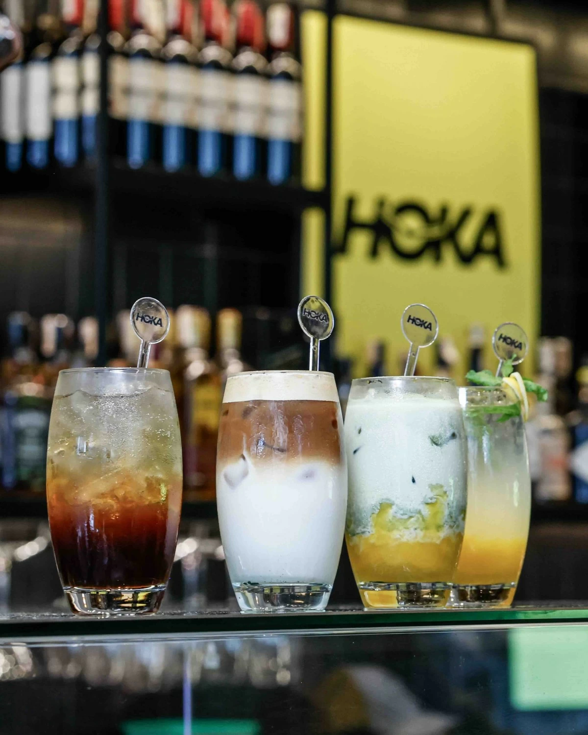 HOKA Sip and Run drink series features Kickstart Crush, a passion fruit cold brew spritz; Sunrise Glide, a toffee nut shaken espresso; Tropic Tempo, a mango matcha latte; and Recovery Rush, a mango mint lemonade