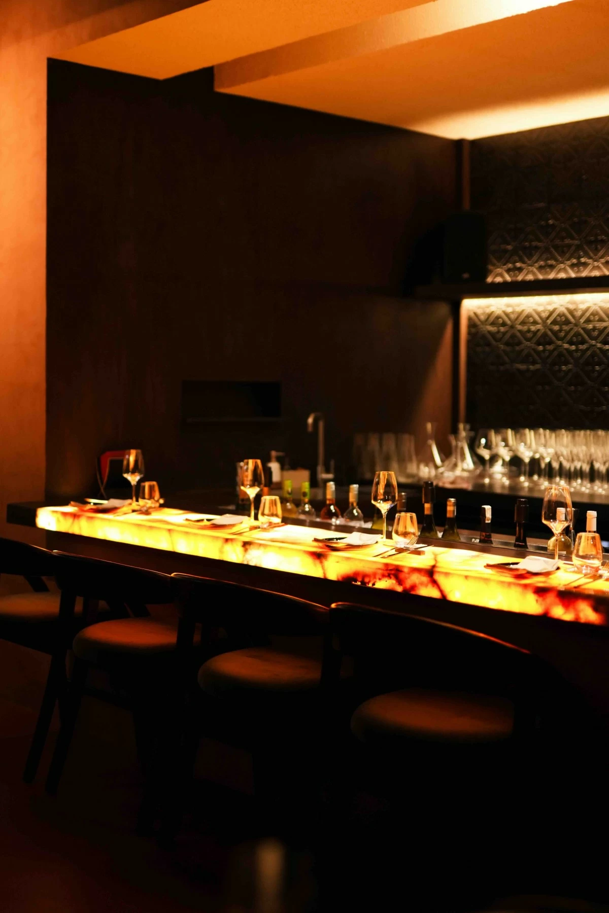 BAR DRAMA The bar at Matador commands attention with its lighted marble, low lighting, and theatrical warmth.