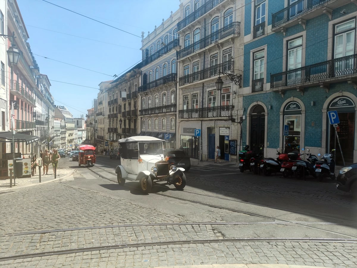 Electric vehicles designed to look like pre-war vehicles bring tourists around the city.