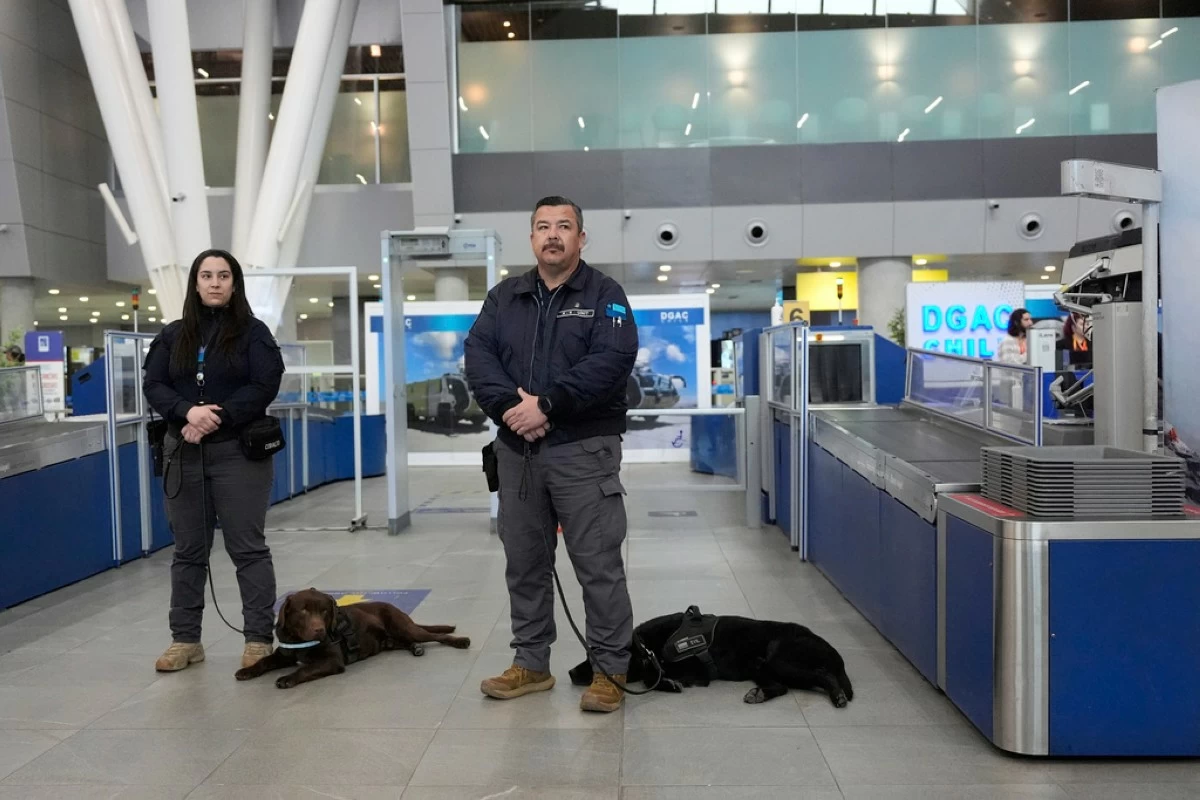Chilean security agents stand with their sniffer dogs during a a security demonstration related to TSA screening and a Biometric Identification Transnational Migration Alert Program (BITMAP) at the Arturo Merino BenÌtez International Airport, Wednesday, July 30, 2025, in Santiago, Chile, before the departure of U.S. Homeland Security Secretary Kristi Noem. (AP Photo/Alex Brandon, Pool)