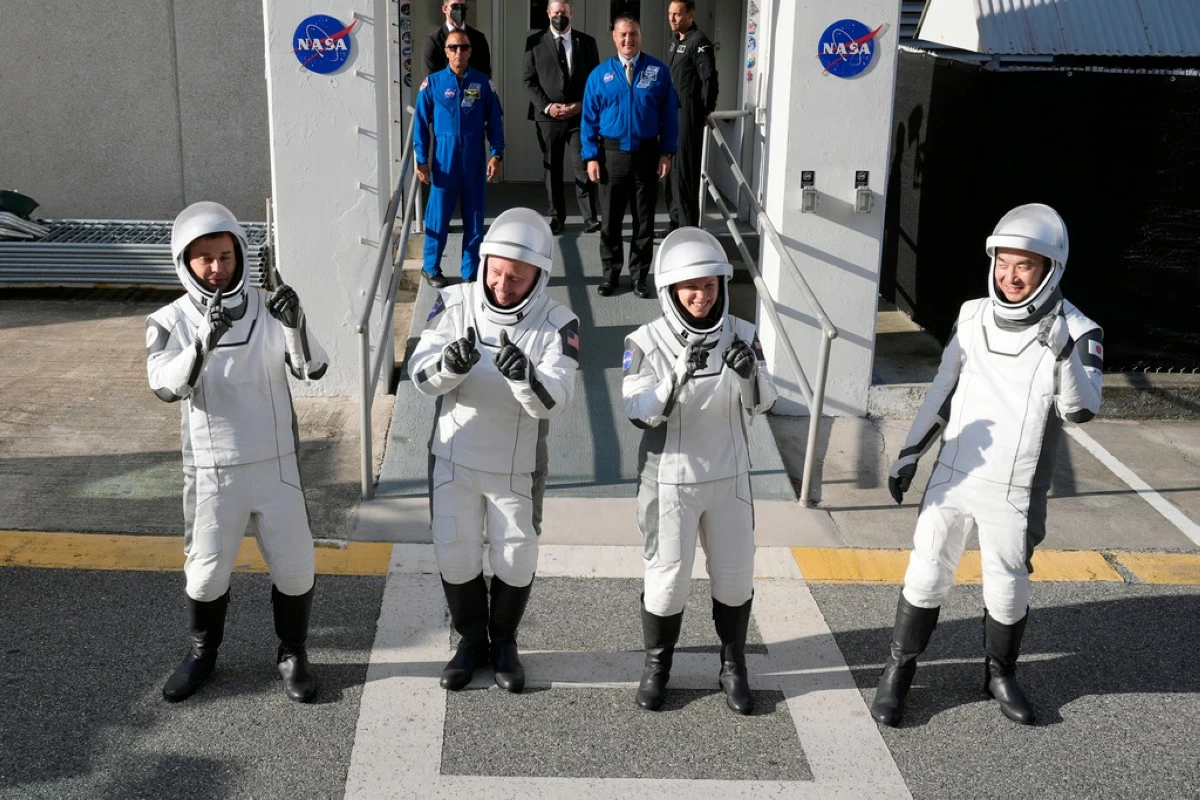 Astronauts, from left, Oleg Platonov, of Russia, Mike Fincke, Zena Cardman, and Kimiya Yui, of Japan, pose for a photo as they leave the Operations and Checkout Building for a trip the Kennedy Space Center's Launch Pad 39-A and a planned liftoff on a SpaceX Falcon 9 rocket Friday, Aug. 1, 2025, in Cape Canaveral , Fla. (AP Photo/John Raoux)
