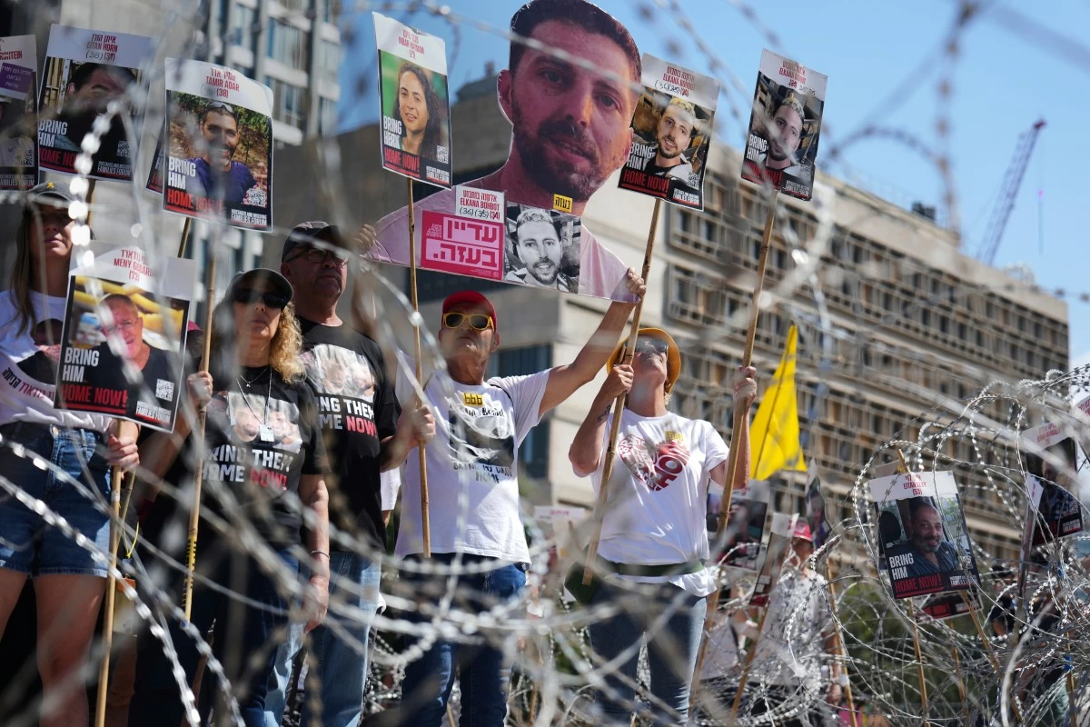 Families of hostages protest, demanding the release from Hamas captivity in the Gaza Strip, at the plaza known as the hostages square in Tel Aviv, Israel, Saturday, Aug. 2, 2025. (AP Photo/Ariel Schalit)