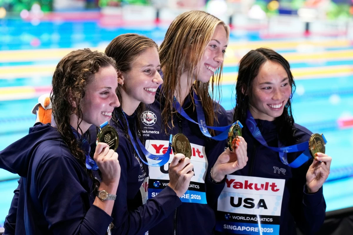 Gold medalists team United States pose after the women's 4x100-meter medley relay final at the World Aquatics Championships in Singapore, Sunday, Aug. 3, 2025. (AP Photo/Vincent Thian)