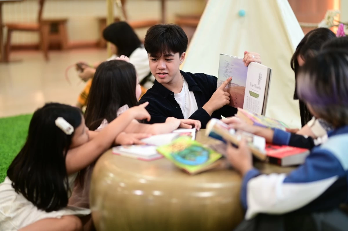 A young boy brings tales to life as he reads to two curious little listeners at the SM Book Nook—creating moments of wonder and imagination through every page.