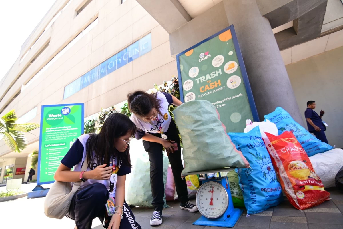 Students weigh recyclables during SM Cares’ Trash to Cash, showing that small actions can lead to a greener future.