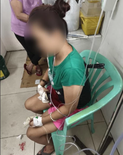 The victim with the “balisong” still embedded in her back. (Photo from Pasay City Police)