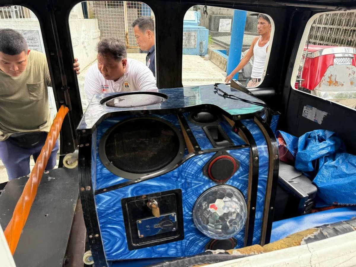MNC Director Daniel Dandan Tan confiscated a videoke machine and destroyed bottles of alcoholic beverages found inside the cemetery.  (Photo from the Manila North Cemetery)
