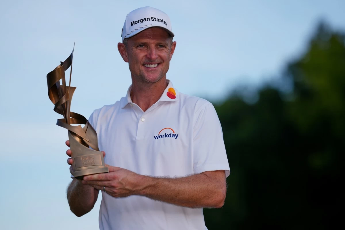 Justin Rose, of England, holds the trophy after winning the St. Jude Championship golf tournament Sunday, Aug. 10, 2025, in Memphis, Tenn. (AP Photo/George Walker IV)