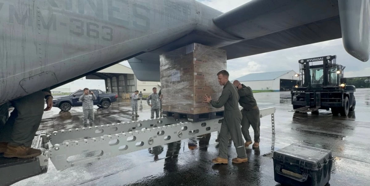 U.S. Marines and Philippine Airmen prepare the delivery of Department of Social Welfare and Development (DSWD) family food packs at Clark Air Base. (Photo by Philippine Air Force)