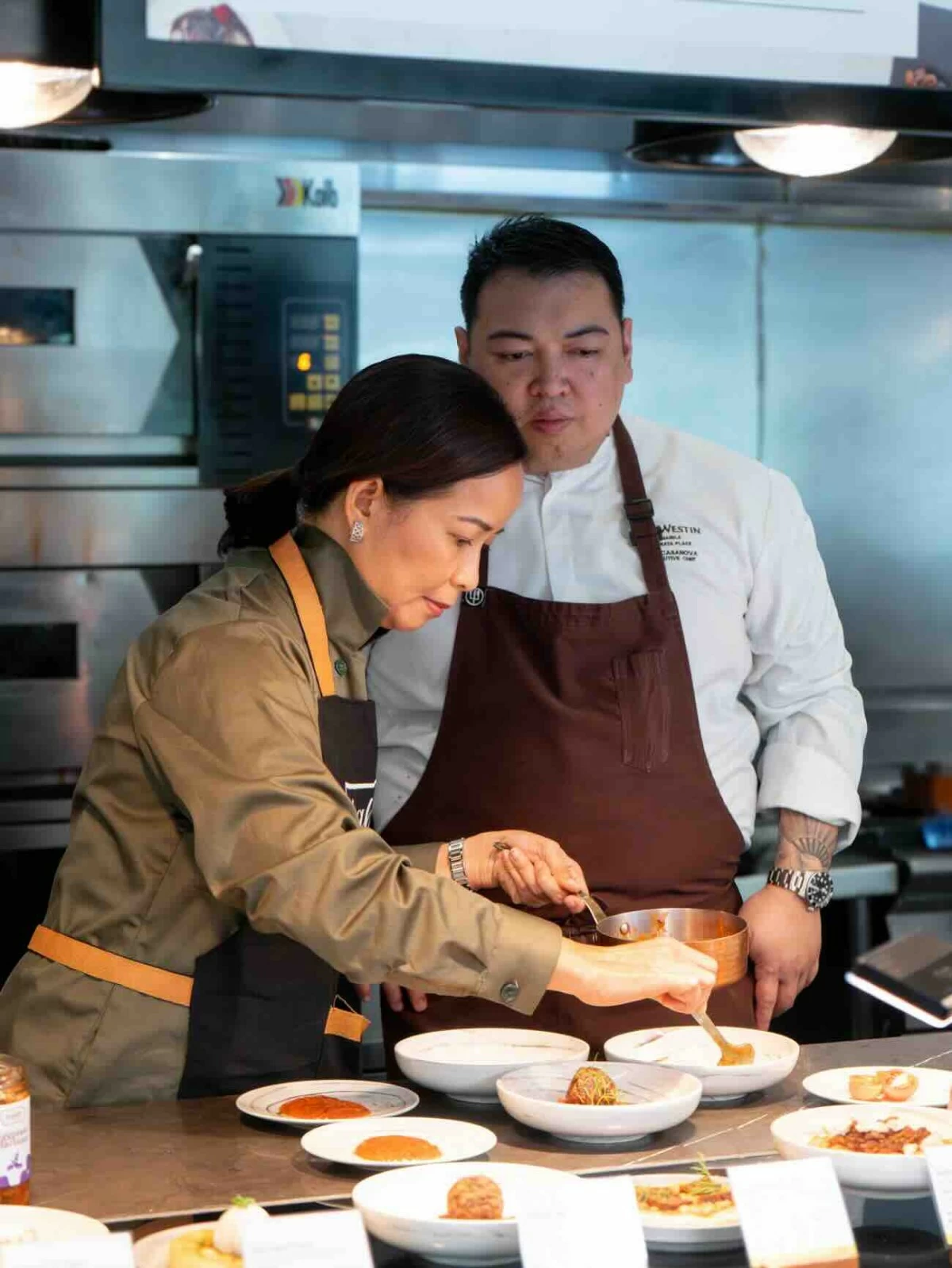 Chef Mia Sison plating a dish at Seasonal Tastes