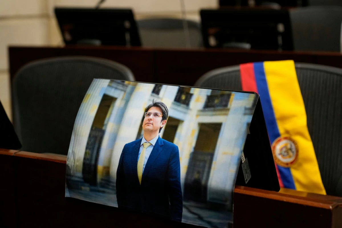 A photo of opposition Sen. Miguel Uribe is placed at his seat in Congress in Bogota, Colombia, Monday, Aug. 11, 2025, after his death more than two months after being shot during a political rally. (AP Photo/Fernando Vergara)