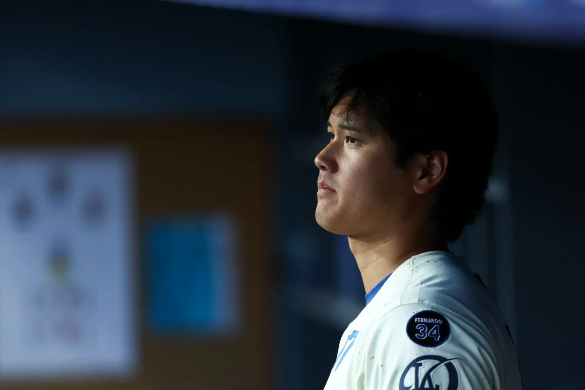 Los Angeles Dodgers' Shohei Ohtani looks on in the dugout during the fifth inning of a baseball game against the Toronto Blue Jays, Saturday, Aug. 9, 2025, in Los Angeles. (AP Photo/Jessie Alcheh)