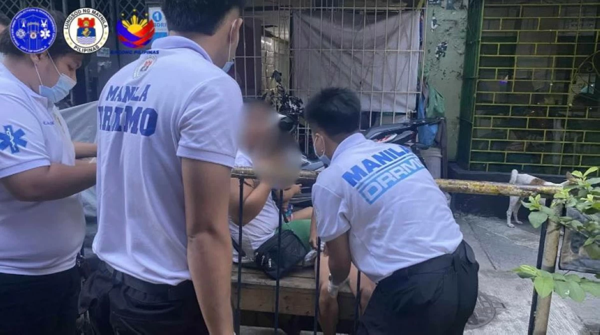 Personnel of the Manila Disaster Risk Reduction and Management Office respond to an injured minor victim of the road accident along Osmeña Highway.   (Photo courtesy of the Manila DRRM Office)