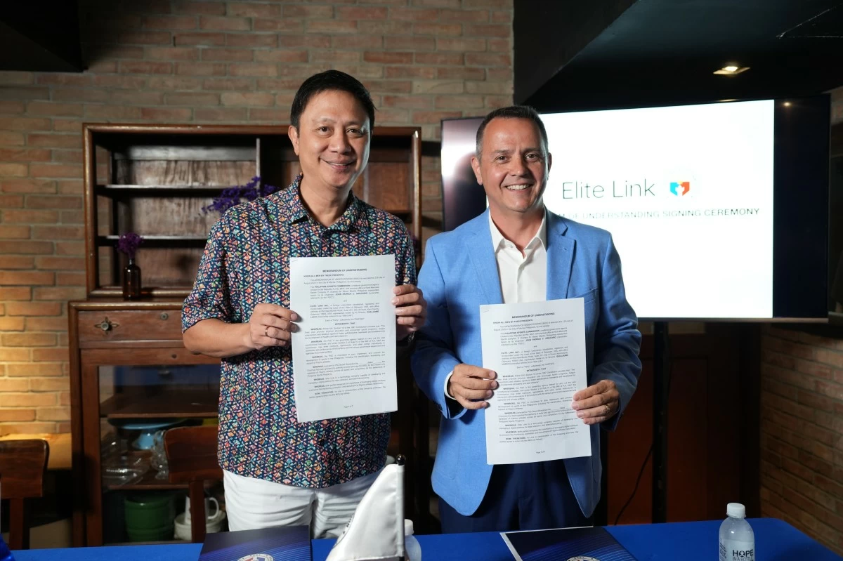 Philippine Sports Commission (PSC) chairman John Patrick Gregorio, left, and Elite Link president and chief executive officer Guillaume Lucci hold copies of the memorandum of understanding for the creation of a digital database and recruitment platform for athletes. The MOU signing ceremony was held at a restaurant in Makati City on Wednesday, Aug. 13.