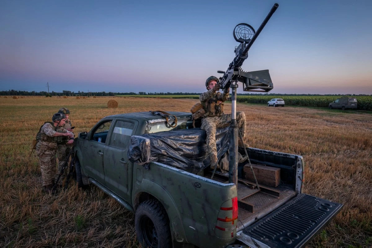 Ukrainian servicemen of the 15th Army Corps stand by an armed pickup truck during night duty in the Chernihiv region, Ukraine, late Tuesday, Aug. 12, 2025. (AP Photo/Dan Bashakov)