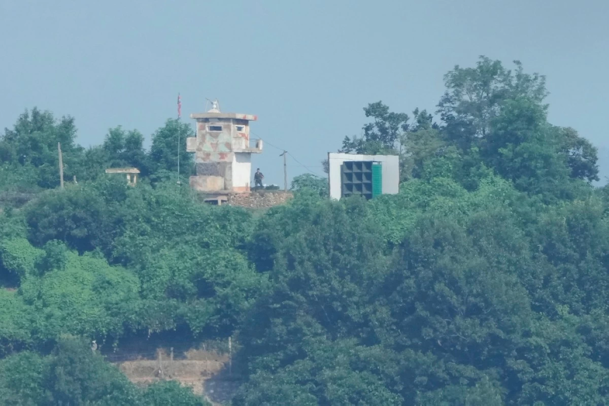 A North Korean military guard post, left, and loudspeaker are seen from Paju, South Korea, near the border with North Korea, Sunday, Aug. 10, 2025. (AP Photo/Ahn Young-joon)