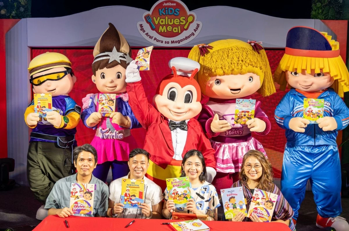 Illustrator Harry Monzon, author Russel Molina, illustrator Jami Bauza, and author Divine Gil Reyes hold the five storybooks highlighting core Filipino values, together with Jollibee and Friends.