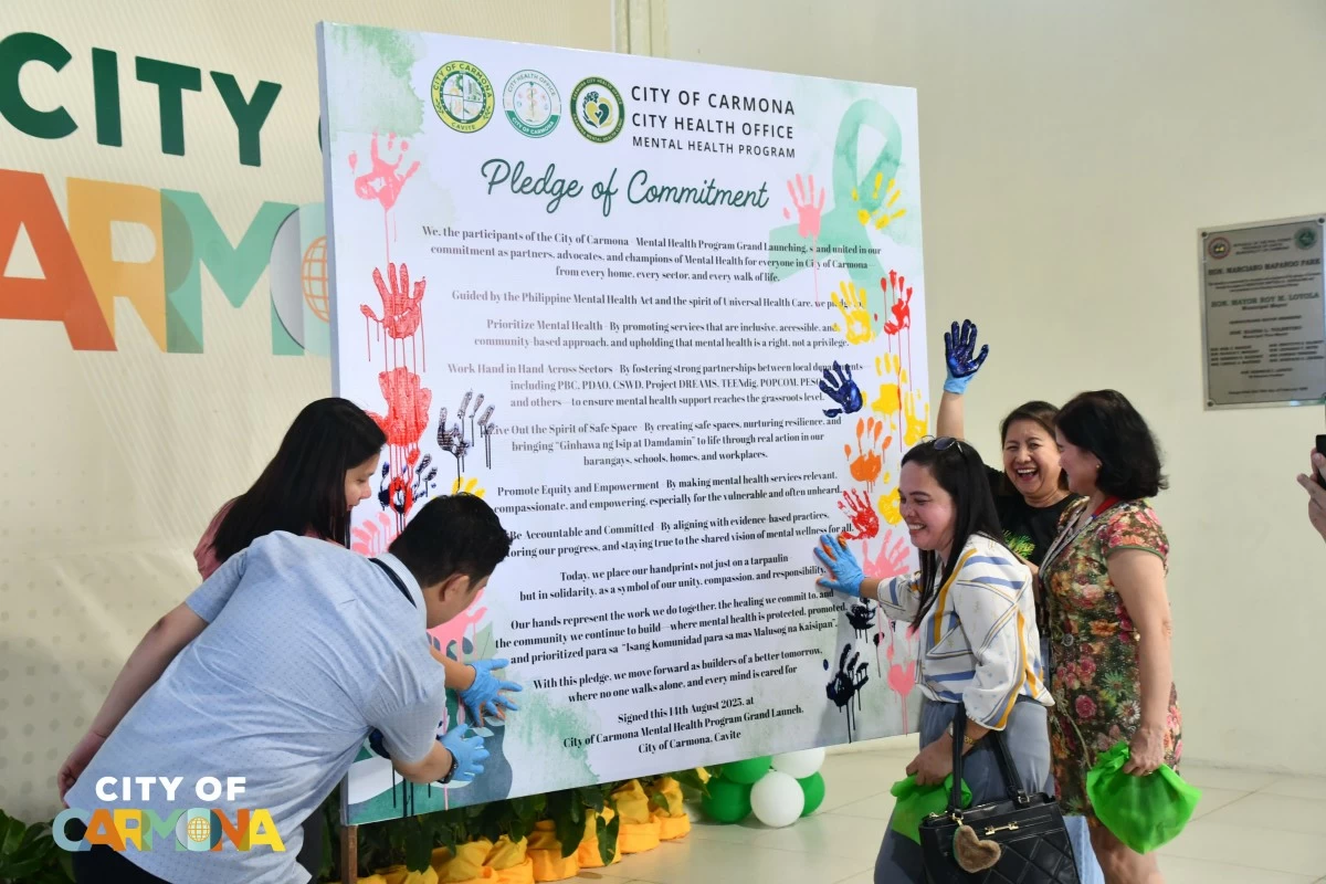 Participants place their colorful handprints on the Pledge of Commitment board during the launch of the Carmona Mental Health Program (Photo from the City Government of Carmona/MANILA BULLETIN)
