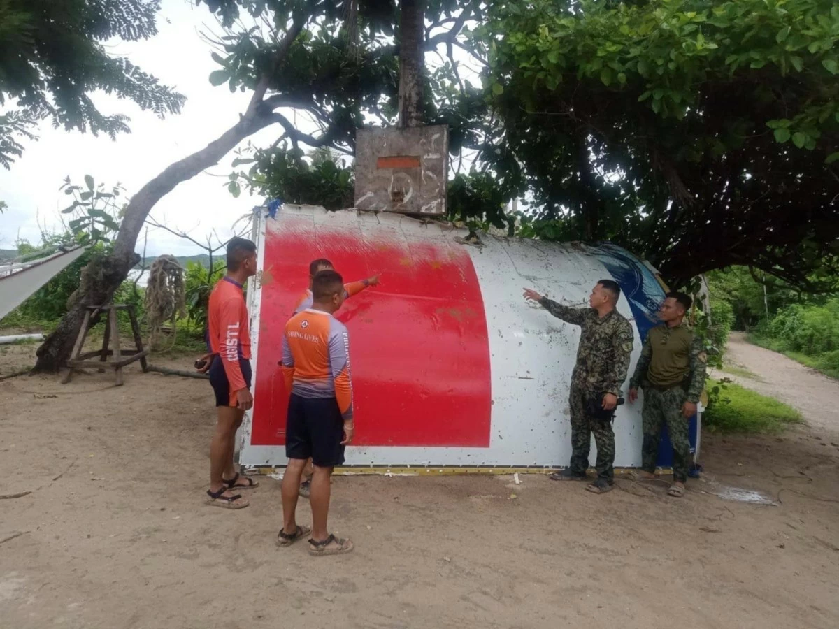 Philippine Coast Guard (PCG) personnel retrieve a floating rocket debris bearing markings of Chinese flag off Looc, Occidental Mindoro on Aug. 14, 2025. (Photo: PCG)