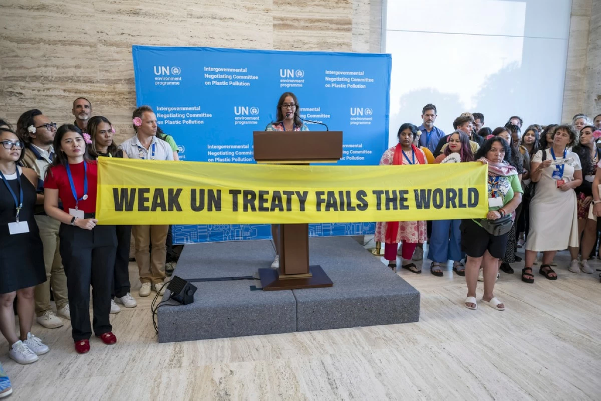 Activists stage a protest during a plenary session of Second Part of the Fifth Session of the Intergovernmental Negotiating Committee on Plastic Pollution at the European headquarters of the United Nations in Geneva, Switzerland, Thursday, Aug. 14, 2025. (Martial Trezzini/Keystone via AP)