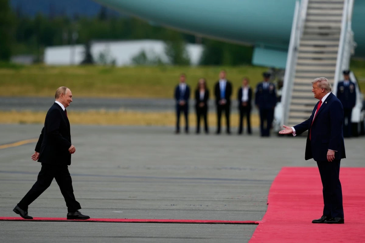 President Donald Trump greets Russia's President Vladimir Putin Friday, Aug. 15, 2025, at Joint Base Elmendorf-Richardson, Alaska. (AP Photo/Julia Demaree Nikhinson)