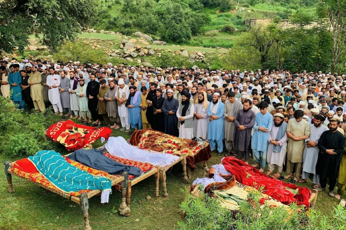 People attend funeral prayers of the victims of cloudburst incident, in Salarzai, Pakistan, Friday, Aug. 15, 2025. (AP Photo/Anwarullah Khan)