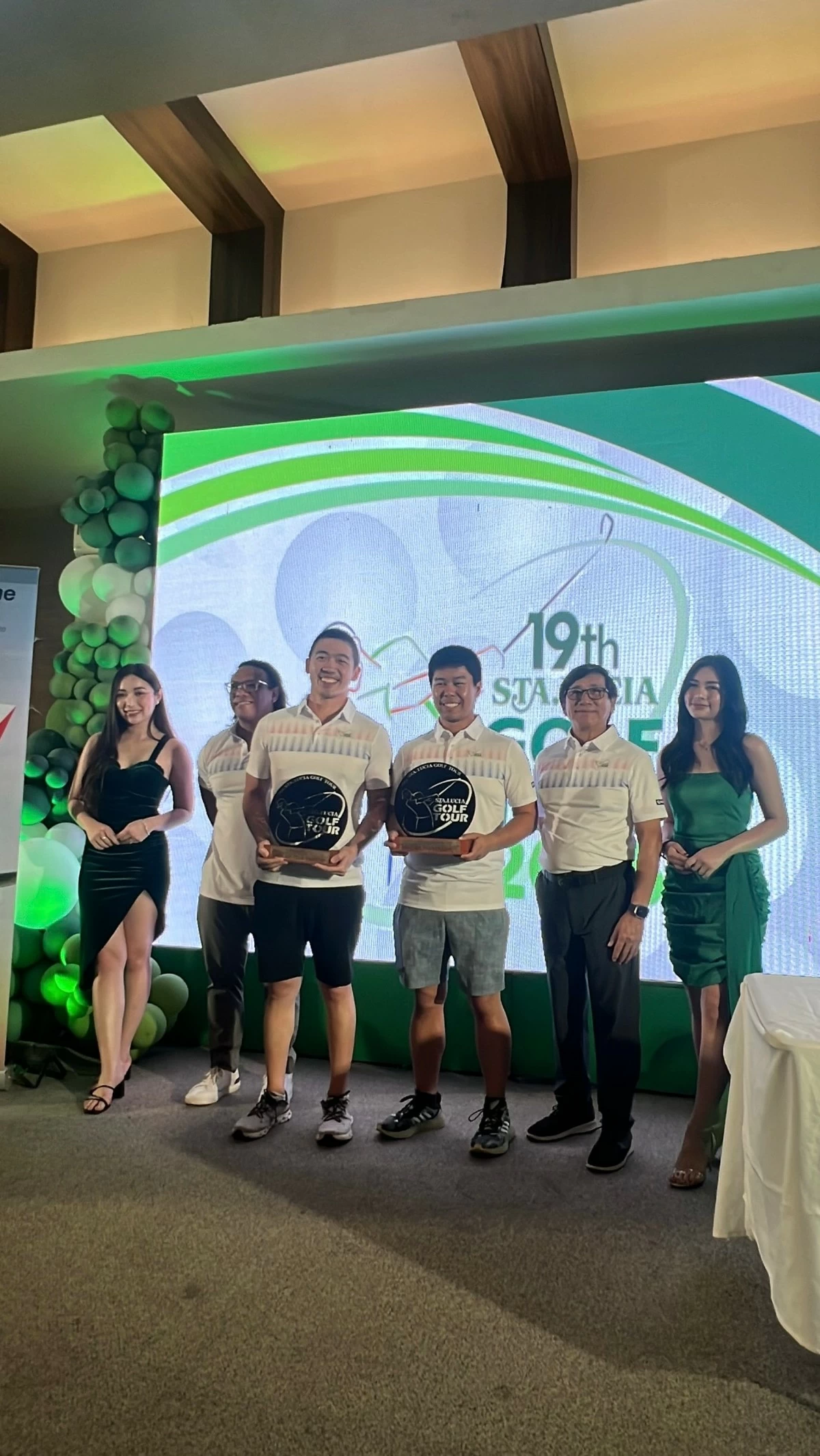 Ralph Chong and Aldric Yao, center, flex their trophy.
