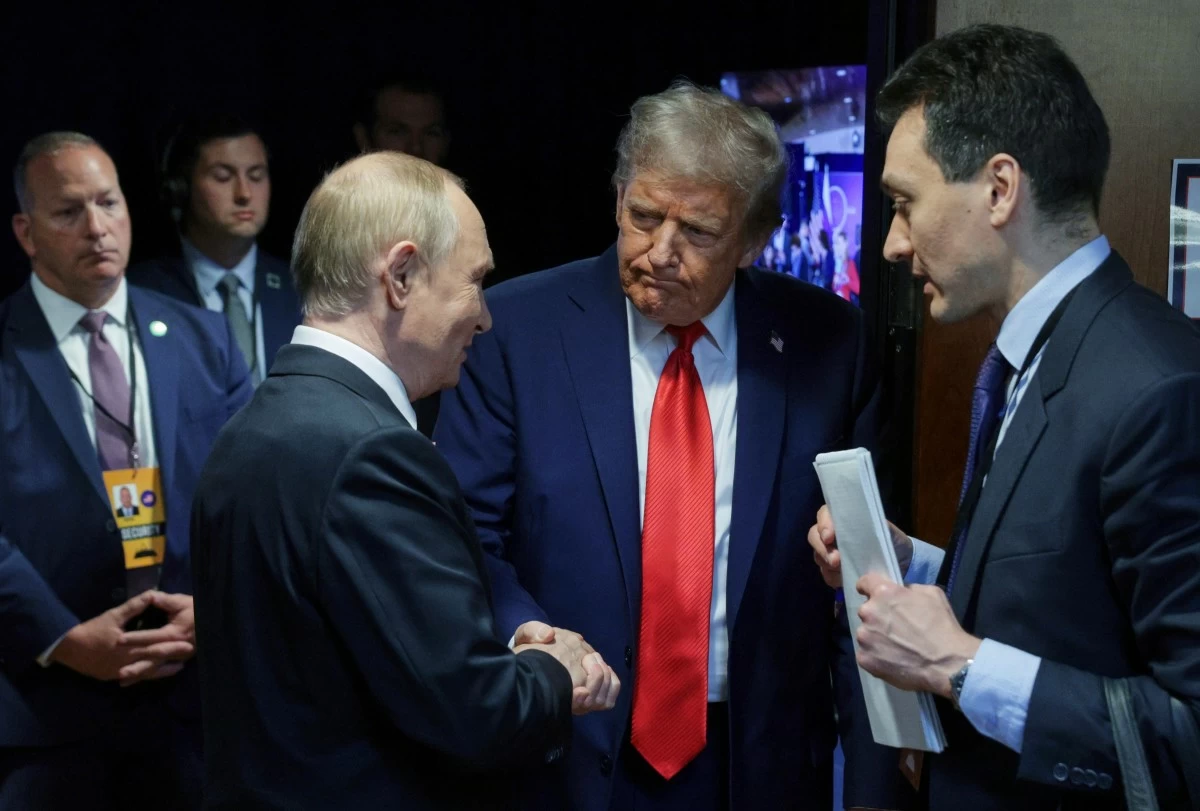U.S. President Donald Trump, second right, shakes hands with Russian President Vladimir Putin after their joint news conference on Friday, Aug. 15, 2025, at Joint Base Elmendorf-Richardson, Alaska. ((Gavriil Grigorov, Sputnik, Kremlin Pool Photo via AP)