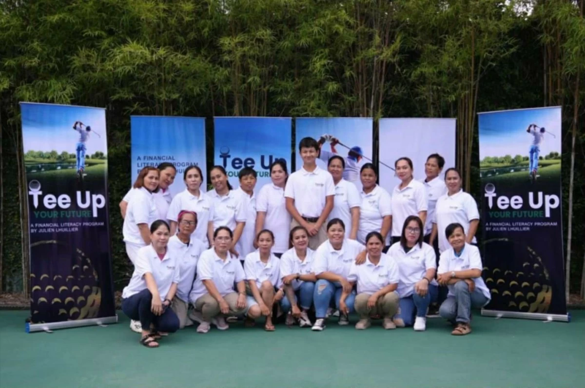 Julien Lhuillier (standing, center) poses with golf caddies who participated in the initial "Tee Up Your Future" program.
