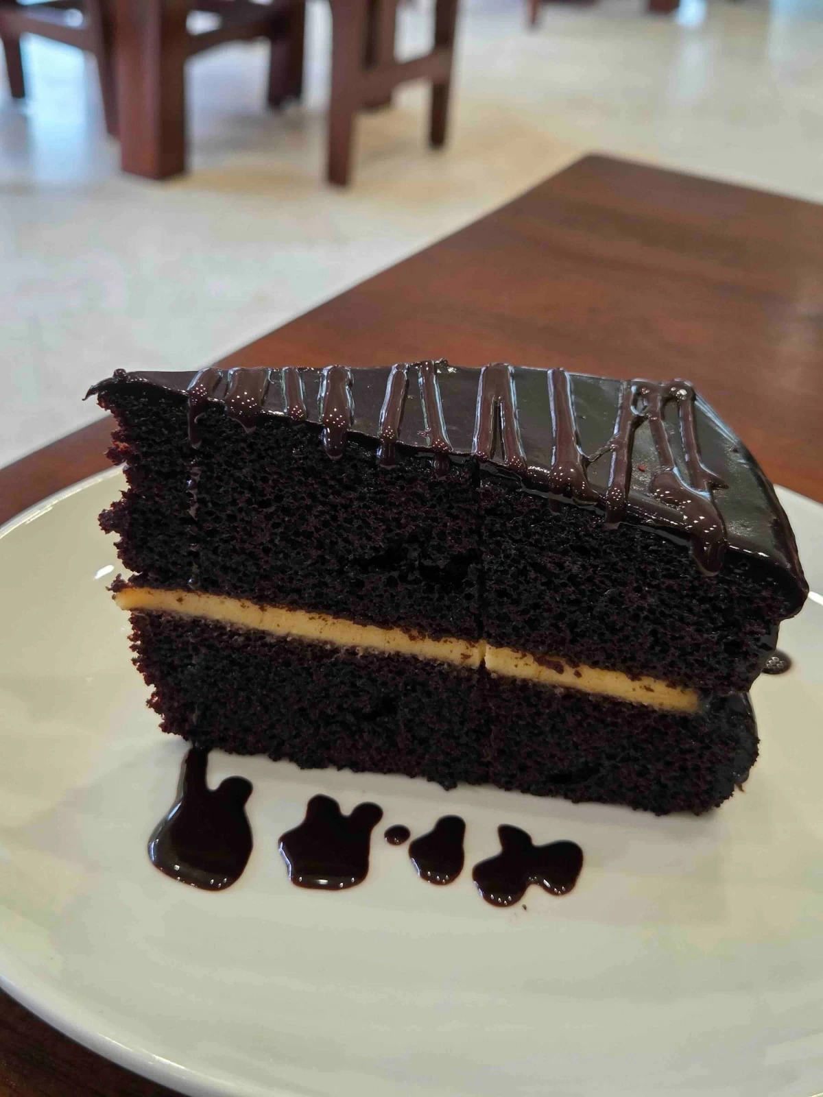 CHOCO NOSTALGIA Rich, dense chocolate cake at Quino’s, a Bacolod favorite often compared to cherished heirloom family recipes.