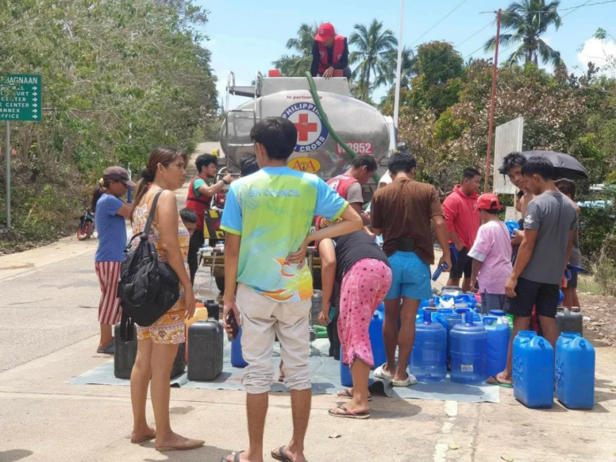 Philippine Red Cross volunteers deliver clean drinking water to Mt. Kanlaon eruption survivors in Negros, part of the 11.9 million liters provided during 237 days of humanitarian aid. (Photo from PRC)