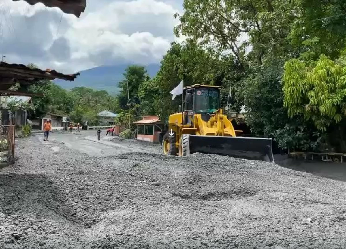 Philippine Red Cross heavy equipment clears lahar and debris from Mt. Kanlaon eruption, restoring road access and supporting recovery in Negros. (Photo from PRC)