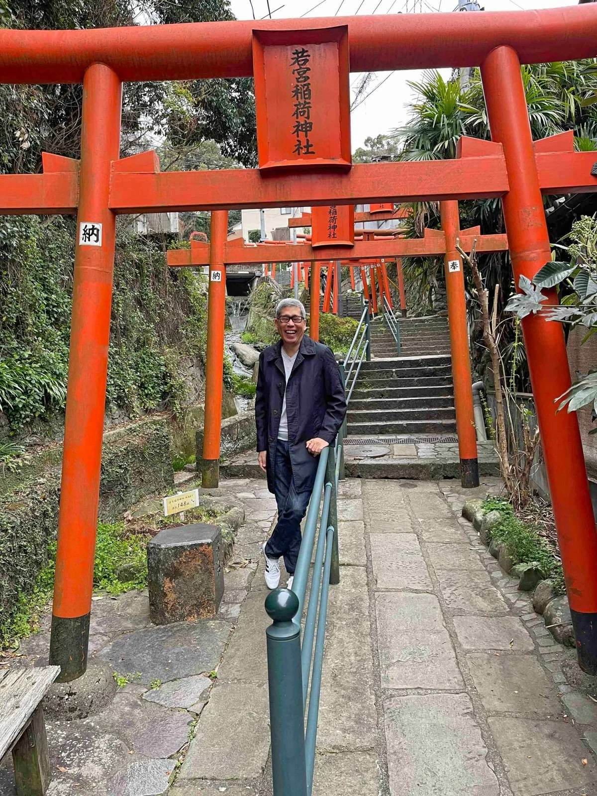 NAGASAKI VIEW Up and down hundreds of stairs through vermilion torii gates, residential communities, and cemeteries.