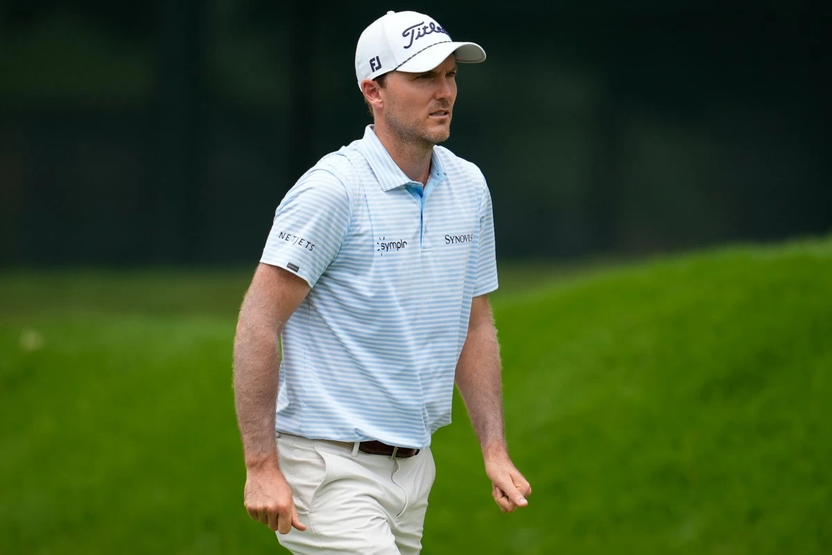 Russell Henley walks on the first fairway during the first round of the Tour Championship golf tournament, Thursday, Aug. 21, 2025, in Atlanta. (AP Photo/Mike Stewart)